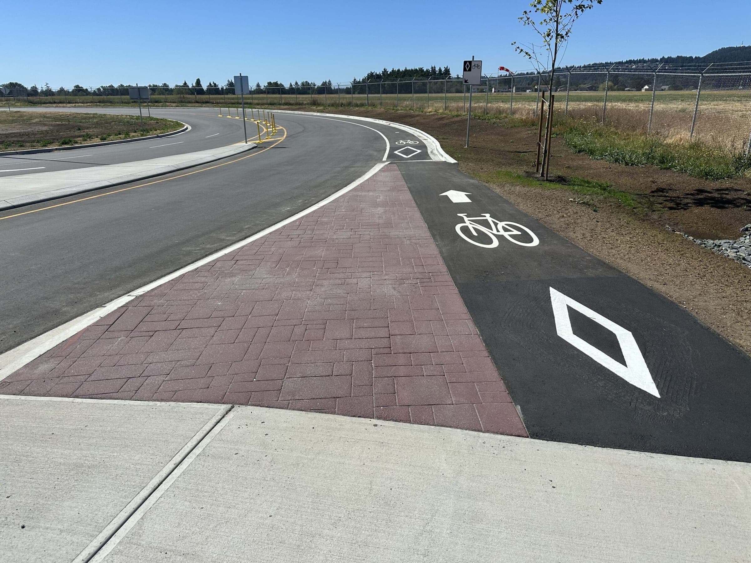 Red brick stamped asphalt multi-use path with bike lane markings