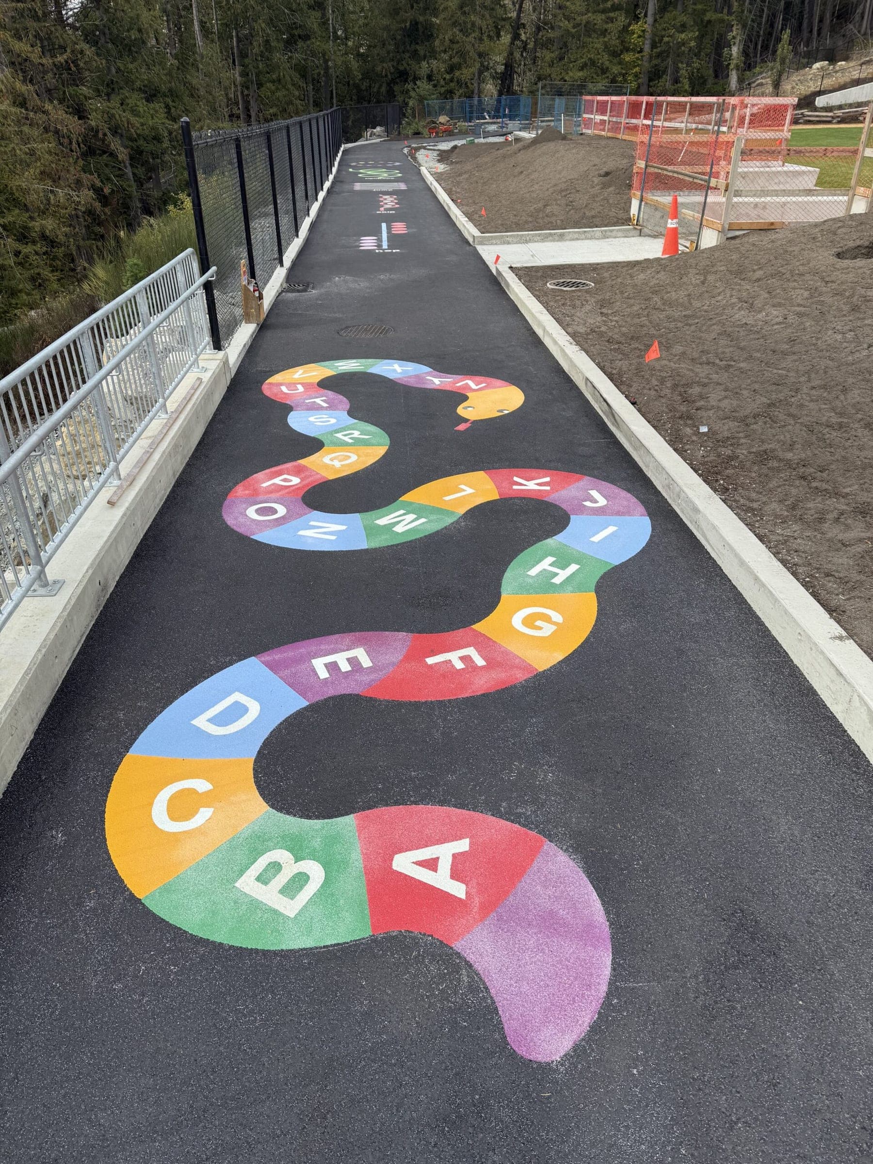 An alphabet path in rainbow-coloured DecoMark winding along a school walkway at South Langford Elementary, Langford