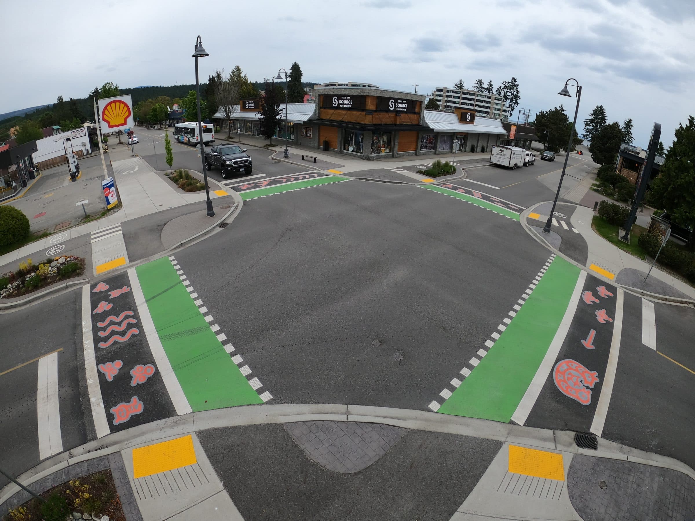 The Cowrie and Trail intersection in Sechelt from above, green StreetBond bike lanes meeting at a crossing