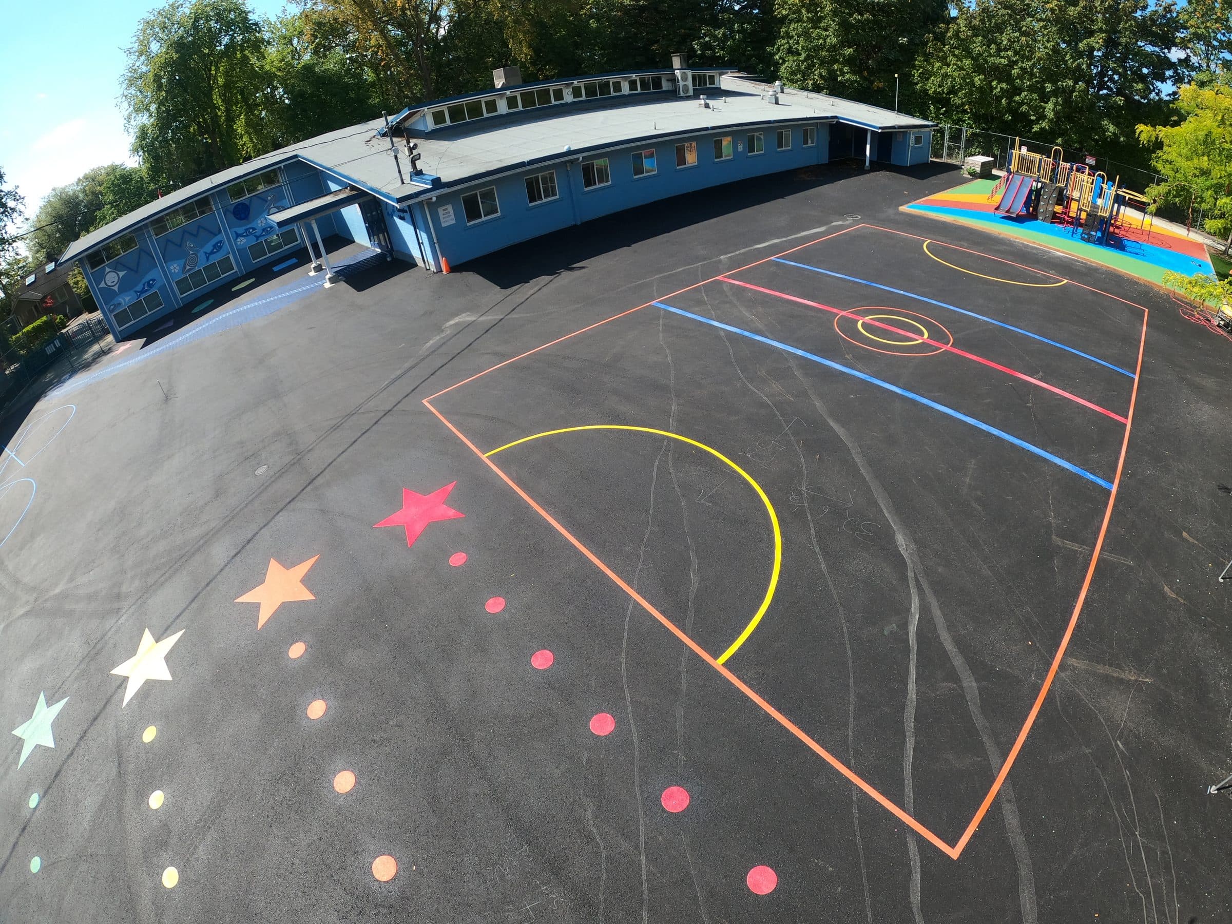 Stars, dots and court lines in PreMark preformed thermoplastic across a school playground in Vancouver, installed by Square One